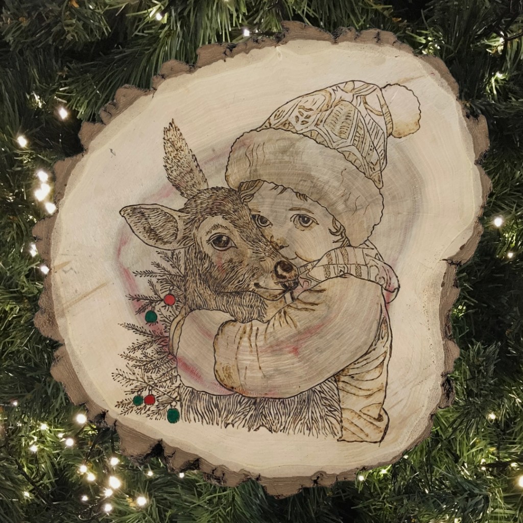 pyrography of a girl with a reindeer